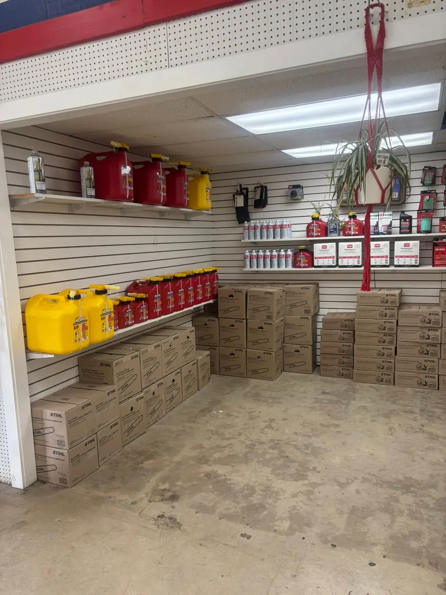 Stockroom shelves with STIHL fuel cans, oils, and maintenance kits